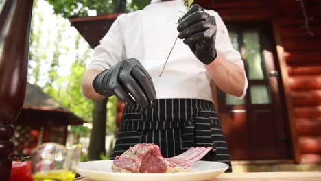 chef preparing lamb ribs outdoors