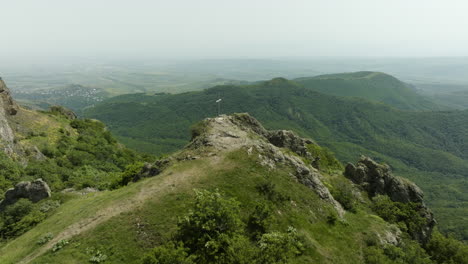 birdseye shot of the forested azeula hill and fortress, and a christian cross