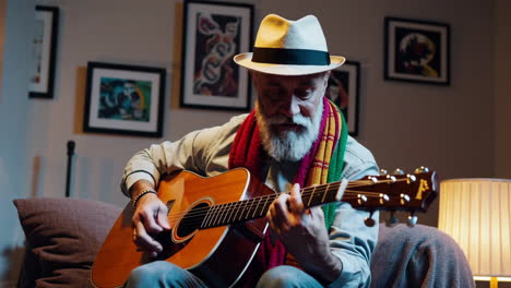 elderly man playing acoustic guitar in living room