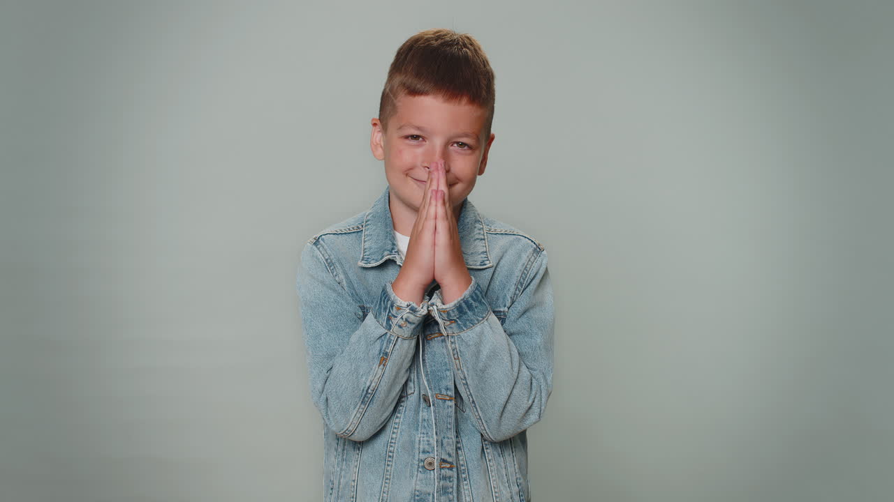 Toddler boy child kid praying, looking upward and making wish, asking for help , begging apology