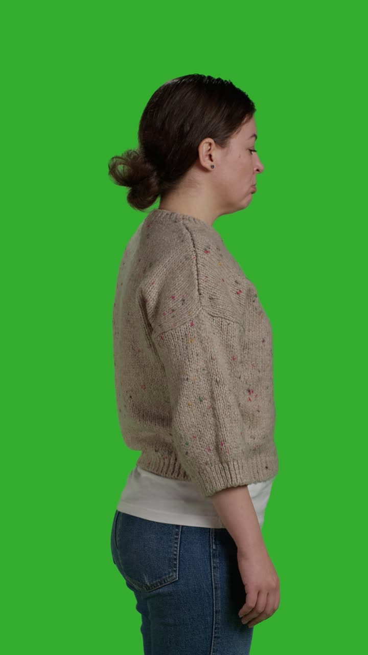 Vertical video: Profile of discontent mad girl acting upset and displeased