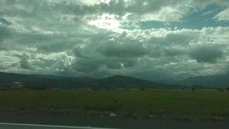 view-from-car-window-with-beautiful-cloudy-sunset-between-mountains-HD