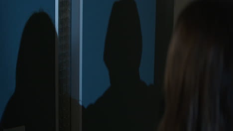 shadow on a wall in a dark hallway