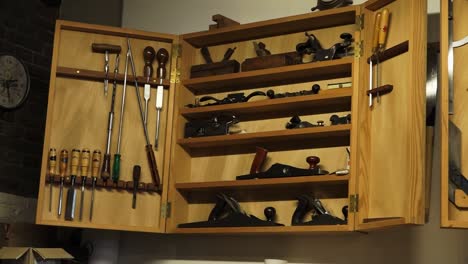 open cupboard with woodworking supplies in woodworkshop