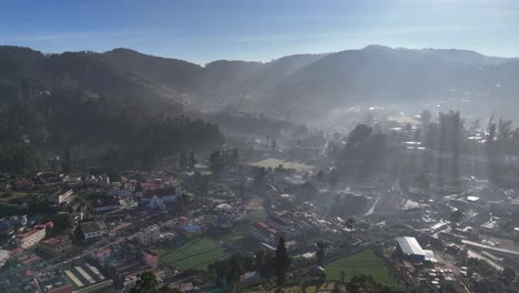 A tranquil sunrise over the mist-covered hills of Ooty.