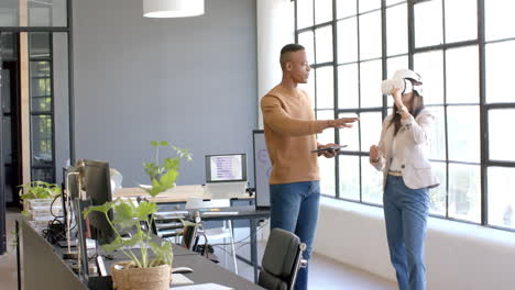 using vr headset, business colleagues collaborating in modern office environment