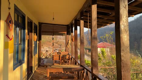 sunrise wind sun light the balcony terrace of a local wooden house cabin in the fall orange yellow autumn color in forest iran wooden dining table offer best view to travel north nature natural park