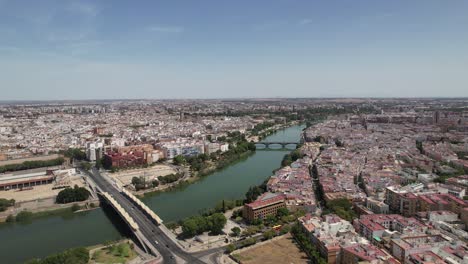 drone flying above the famous guadalquivir river in the center of seville city