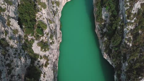 crane up drone shot from inside verdon gorge and its turquoise water, in france