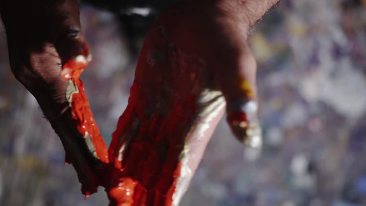Artist mixing paint in hands