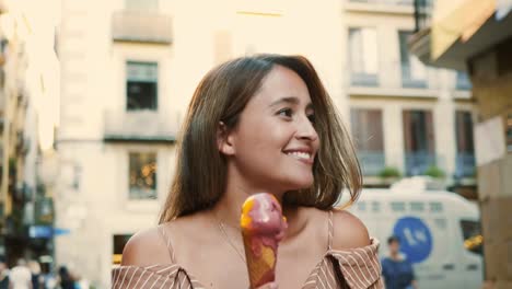 smiling woman walking with icecream cone. cheerful girl licking gelato outdoor.