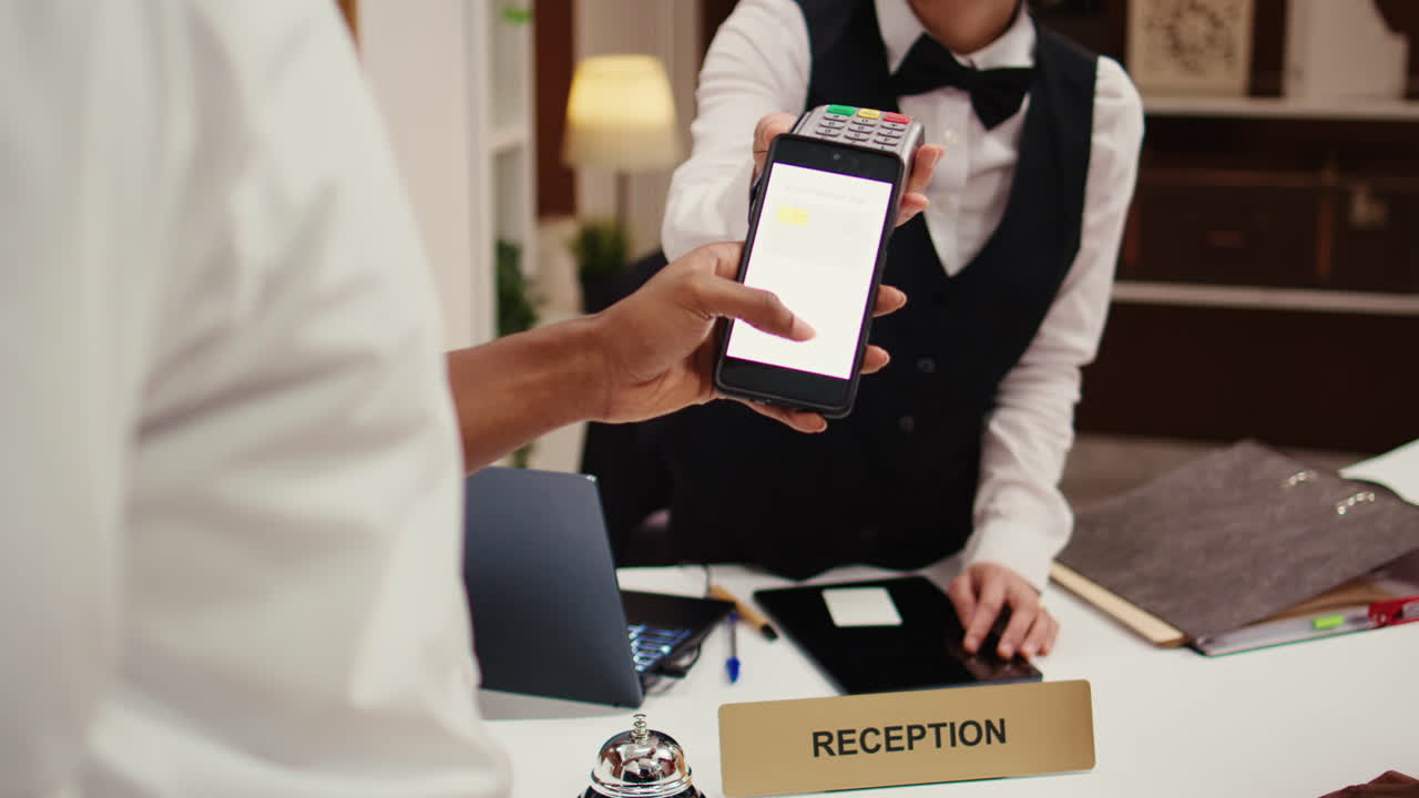 Hotel visitor using smartphone banking