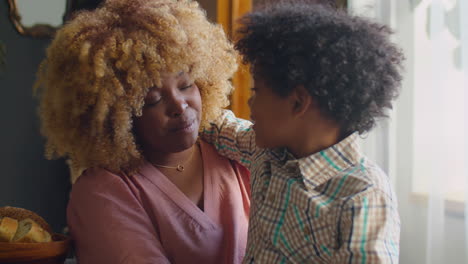 mother talking to little son at dinner table