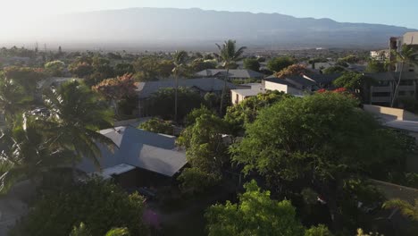 low golden hour morning flight over houses in kihei on island of maui