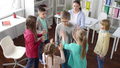 teenager playing trust building game with other kids and psychologist