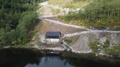 markani hydroelectric powerplant in vaksdal norway - reverse aerial revealing powerplant with landscape behind- 10gwh yearly production and owned by aventron and operated by captiva asset management