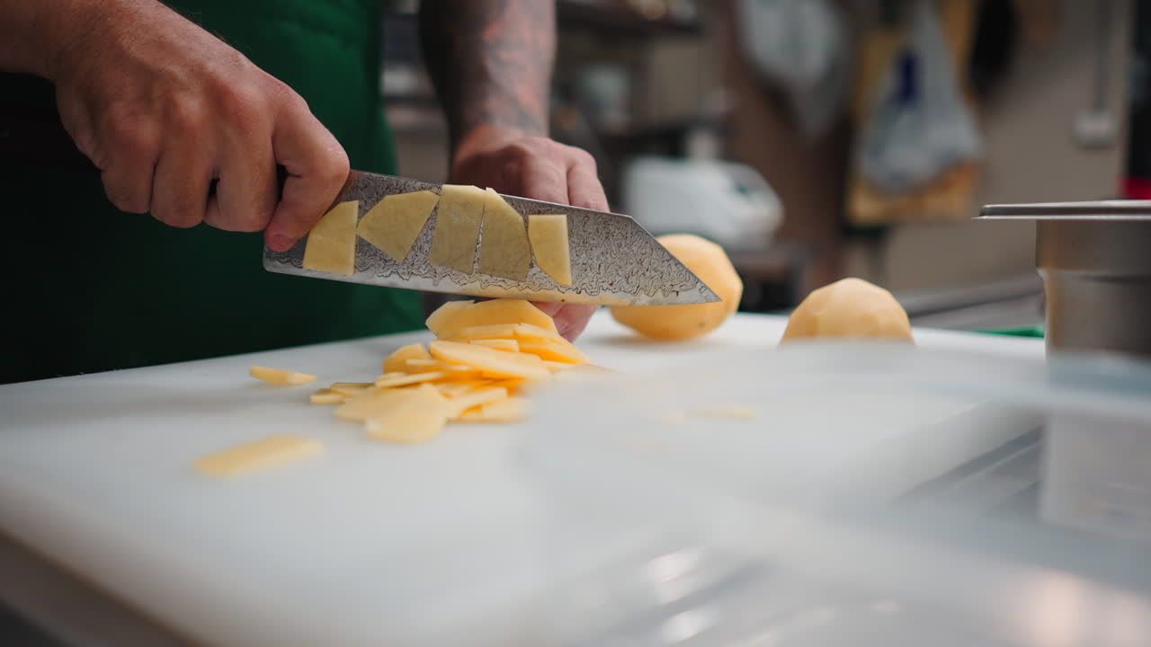 Cutting potatoes in a kitchen