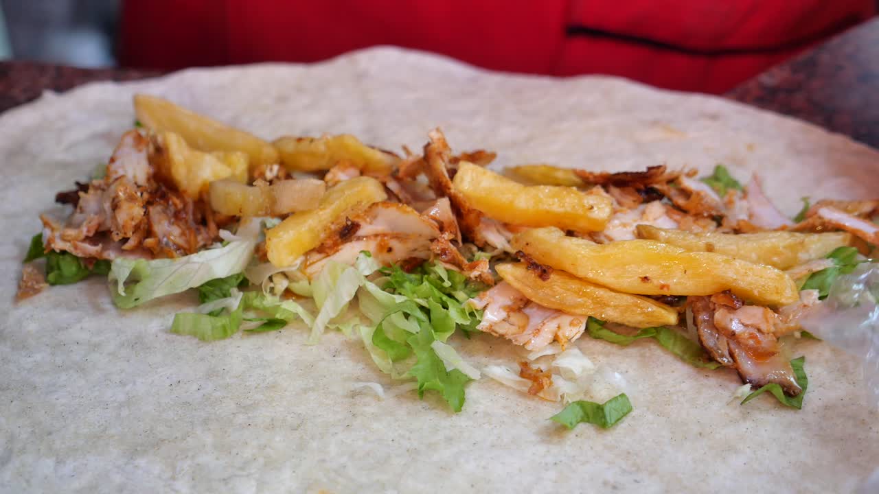 Preparing a chicken shawarma wrap