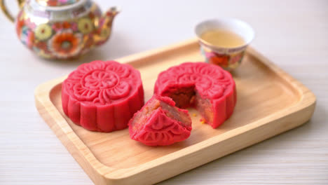 chinese moon cake strawberry red bean flavour on wood plate