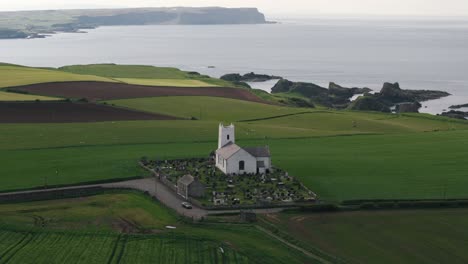 Approaching-Pan-Down-of-Coastal-Northern-Ireland-Church-with-Cliffs-and-Atlantic-Ocean