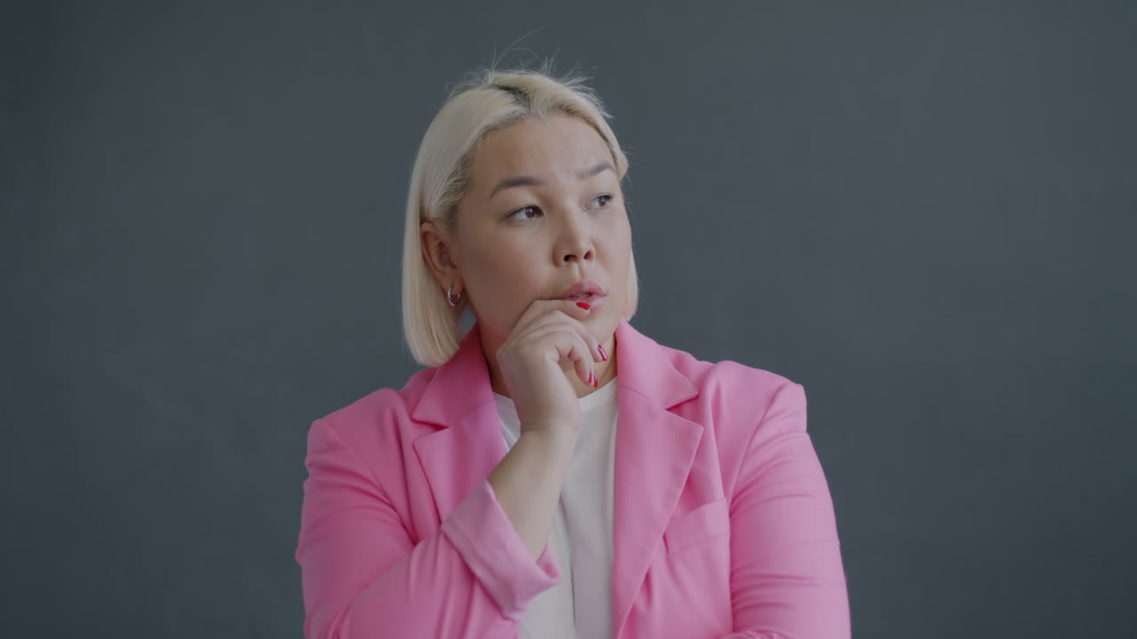 Thoughtful Woman in Pink Blazer