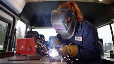 woman welder in a van