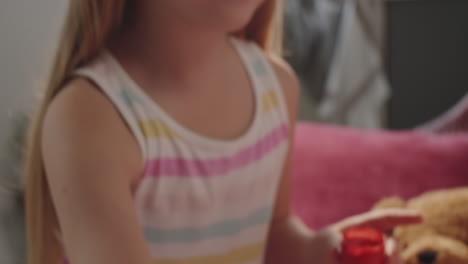 happy little girl painting smile on pregnant belly of mother