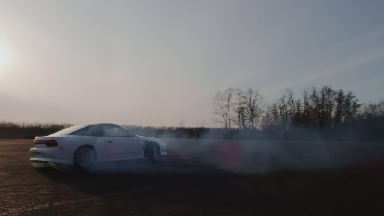White Car Drifting on a Track at Sunset