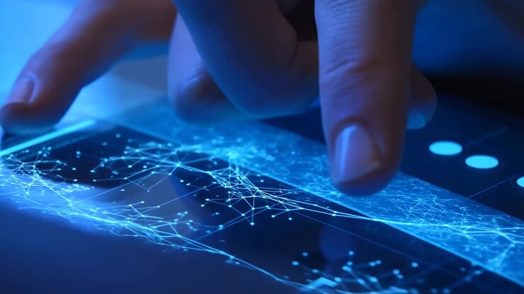 Primer plano de una mano tocando una pantalla táctil brillante con líneas azules luminosas y puntos conectados, sugiriendo flujo de datos, interacción de red y tecnología moderna