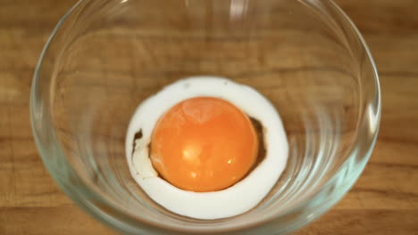 milk is being poured on an egg yolk to make egg wash