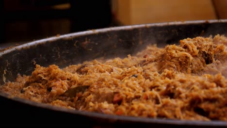 polish dish - bigos. cabbage cooking in a large pot outdoors