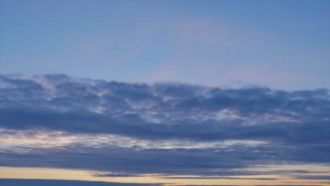 time lapse of beautiful scenic dark blue moving clouds after the sunset, medium shot