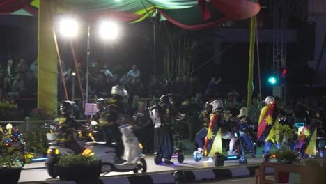 night parade with scooters and flags