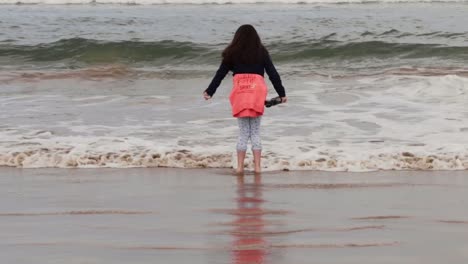 young girl with dark hair enjoying irish sea tide on the coast-1