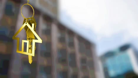 Animation-of-gold-house-key-fob-and-key,-hanging-in-front-of-blurred-city-building