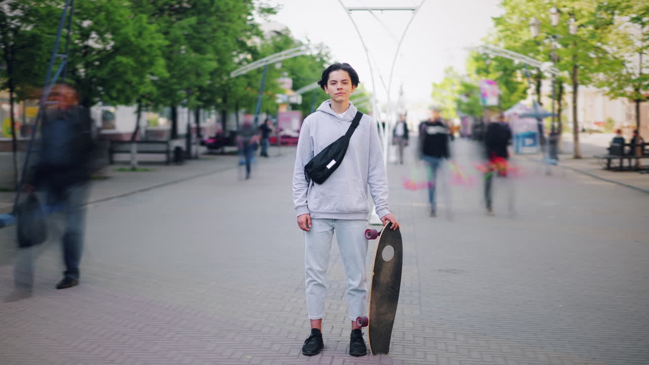 Teenager with Skateboard on City Street
