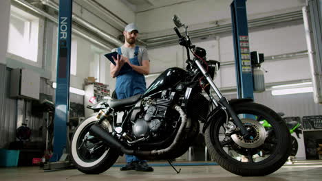 Man-with-cap-writing-at-the-garage