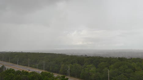 timelapse sheet rain incoming across saturated monsoon woodland highway road