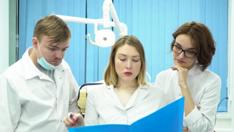 dental team discussing patient records