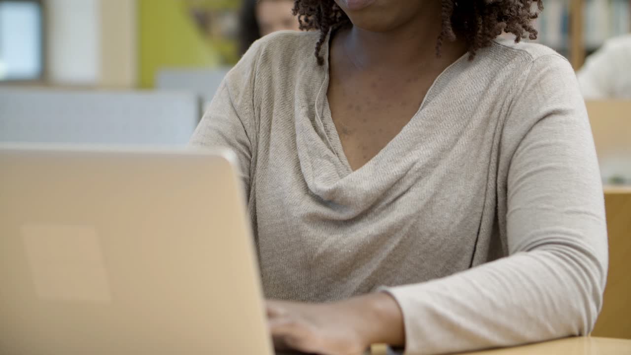 Pensive African American student using laptop