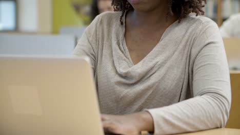 pensive african american student using laptop