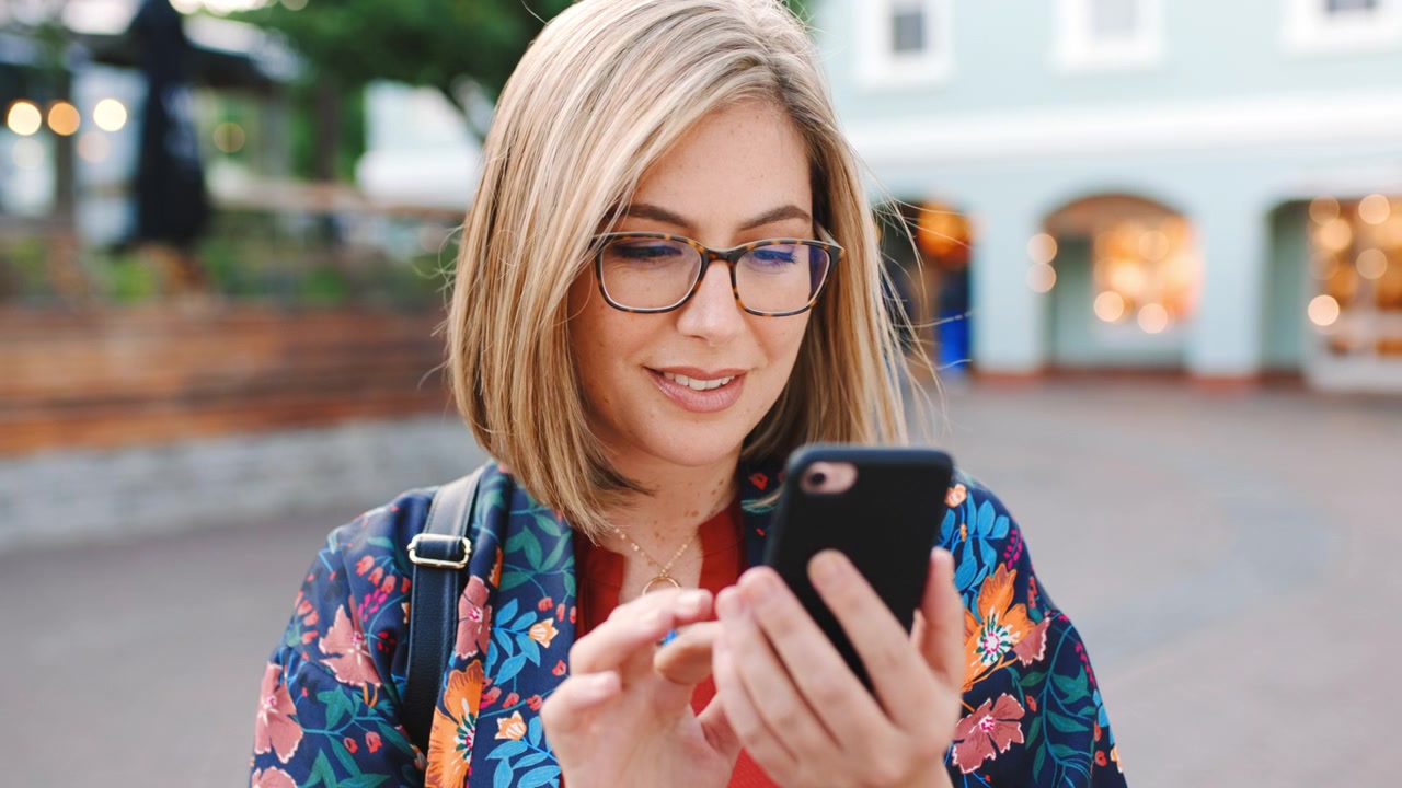 Young Woman Using Smartphone Outdoors in City Center