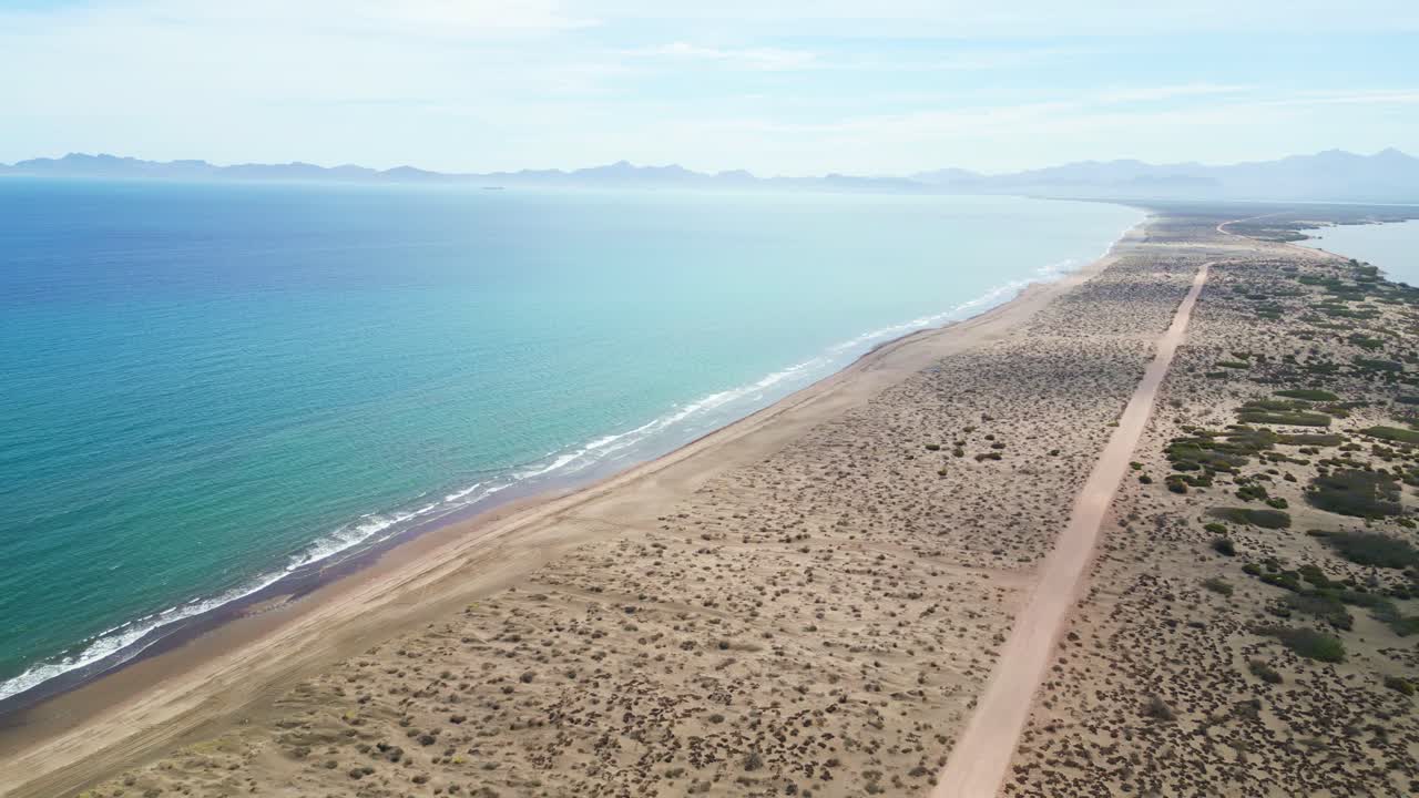 Remote desert sandbar stretching between sea and lagoon near La Paz, El Mogote