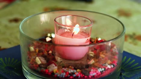 view of a lit pink candle