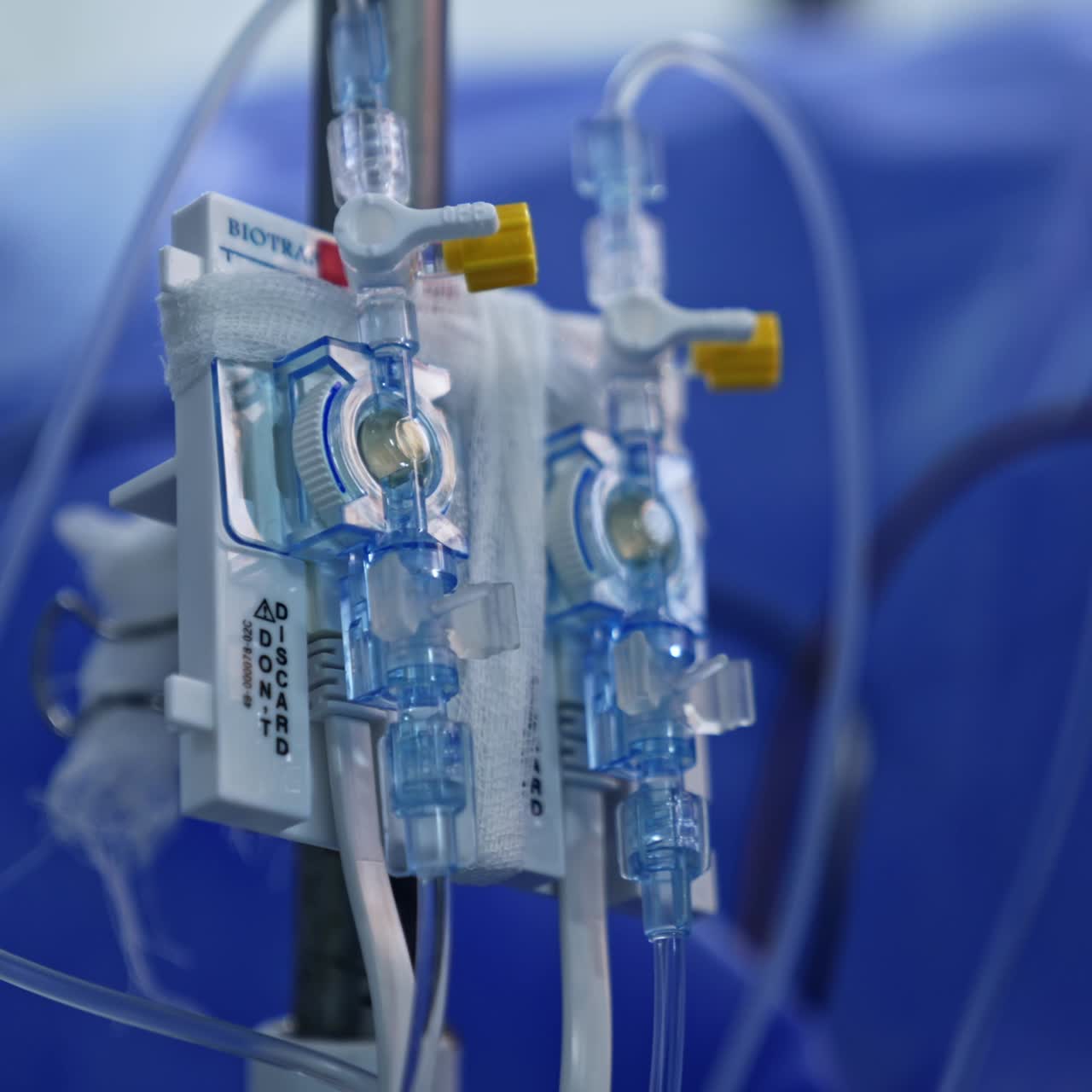 Infusion equipment in the surgery room. Drop counter part with tubes and taps. Close up