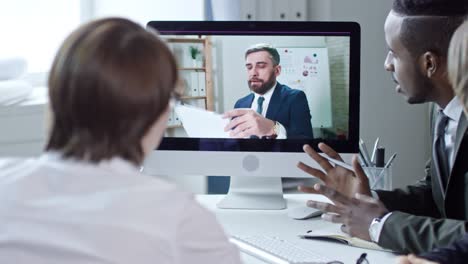 diverse business team web conferencing with colleague