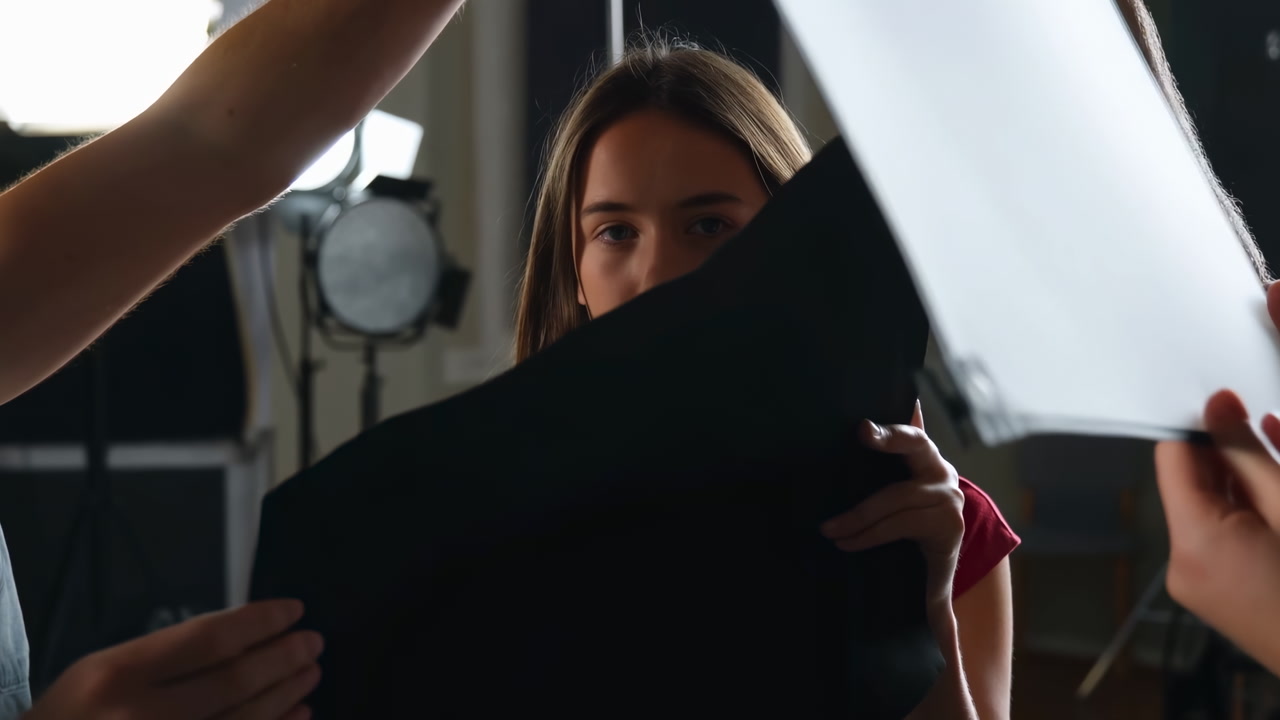 Studio Crew Adjusting White Reflector Near Model, Hands Shaping Catchlight, Cinematic Prep For Portrait Shoot,