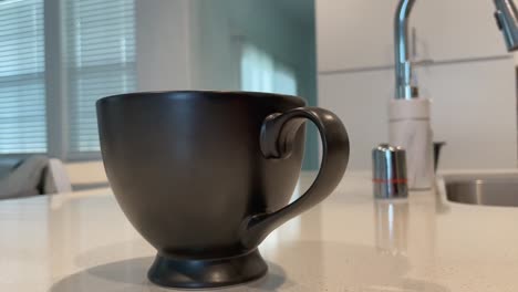 a fresh cup of coffee on a white kitchen countertop