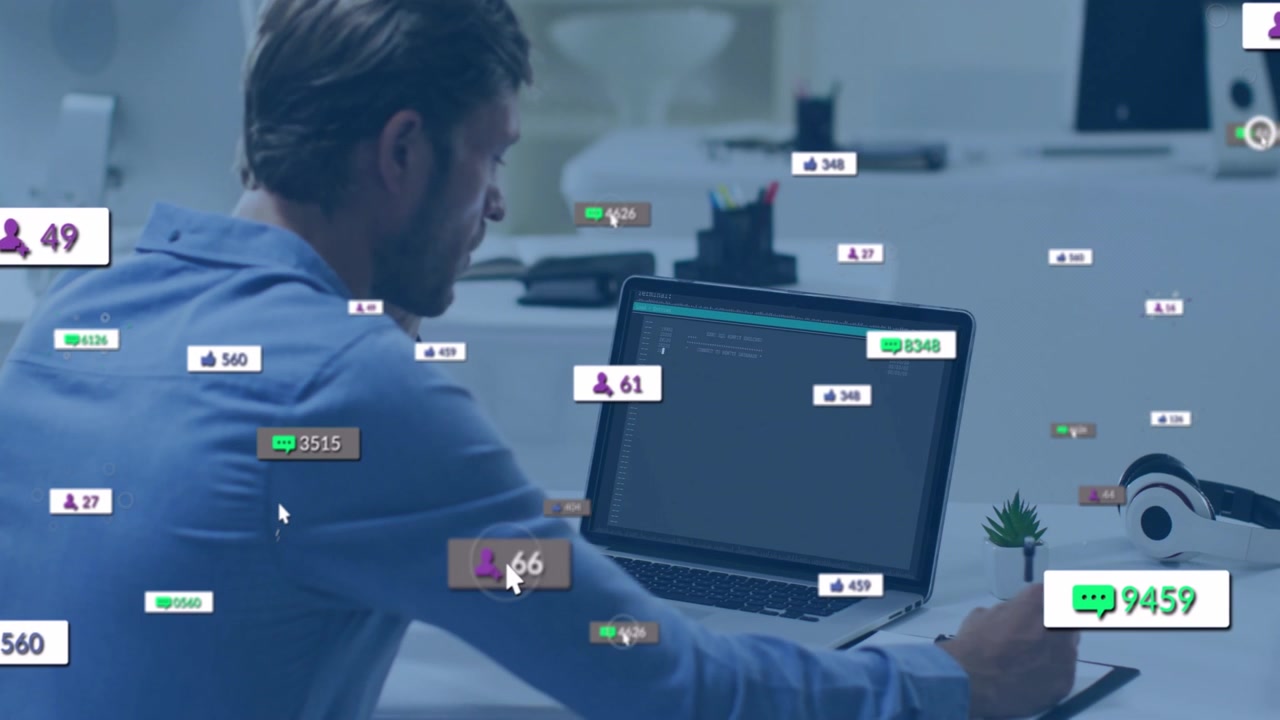 Coder tapping stylus and typing code on laptop while floating social metrics swirling deskward
