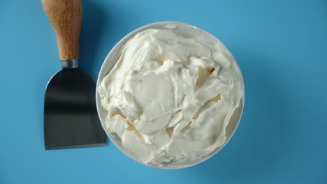 a plate of mascarpone cheese slowly rotates.